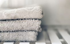 White towels piled in a sink.
